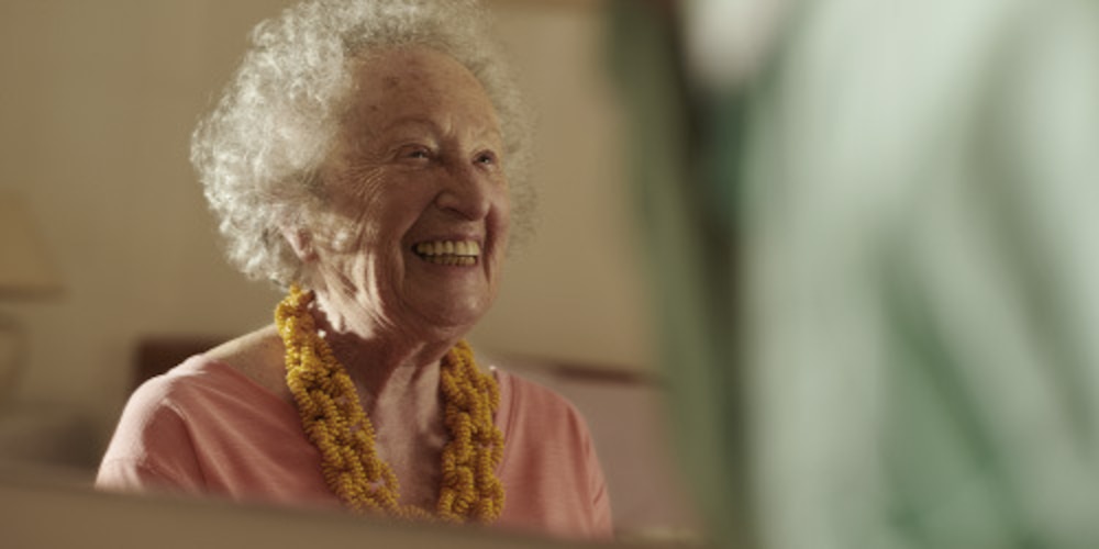 Woman smiling, receiving at home care