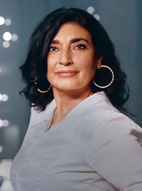 Woman with white blouse and golden earrings