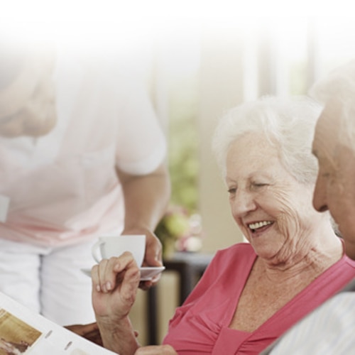An older woman and man laughing together