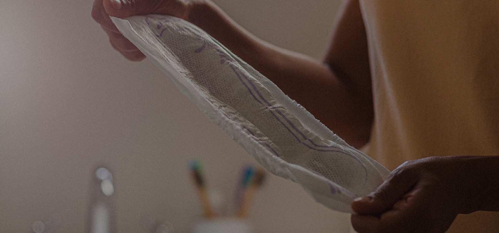 Woman stretching out a TENA Pad 