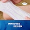 Close up image of person holding the TENA Discreet Ultra pad with the caption "improved design"