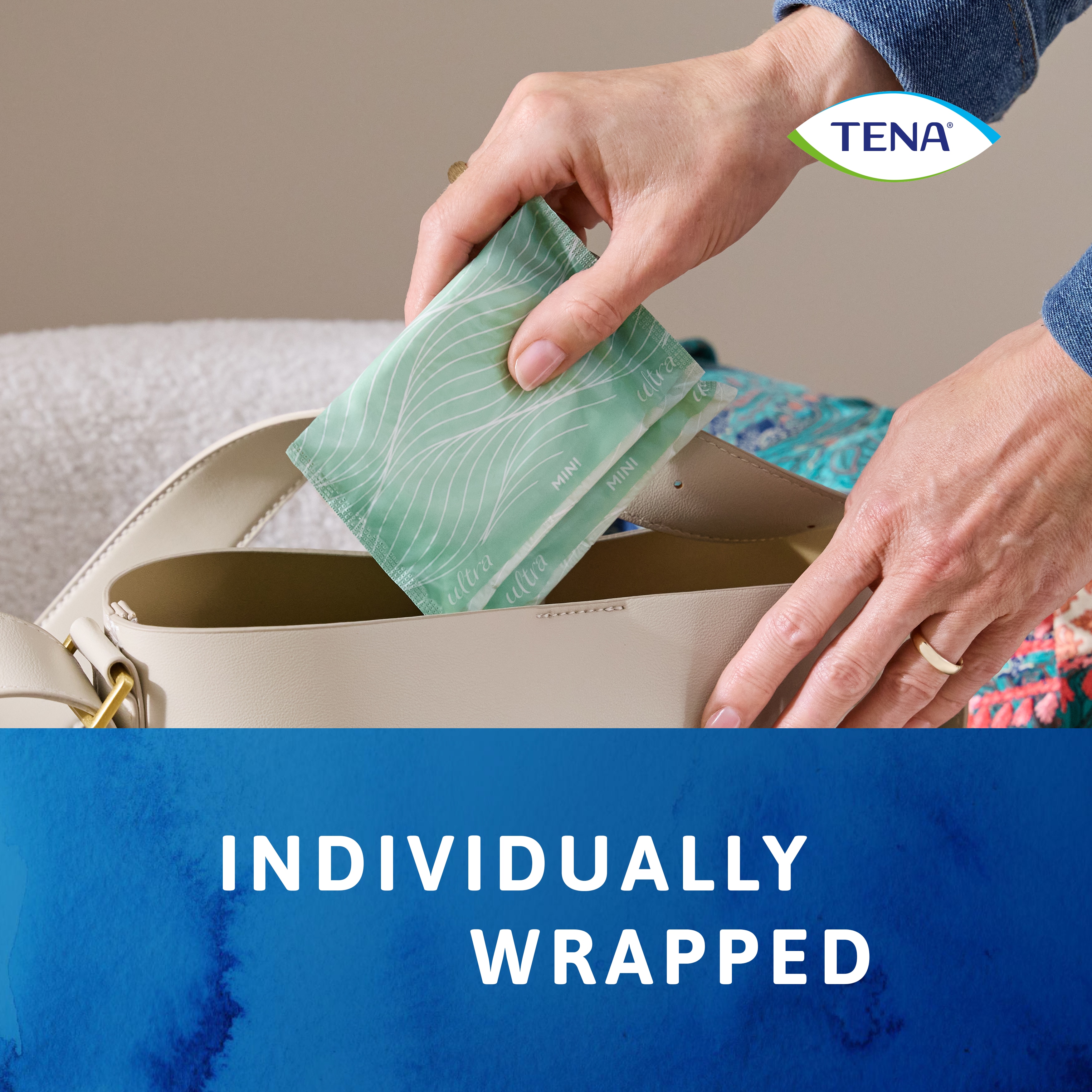 Putting the individually wrapped TENA Discreet Ultra Pad into handbag