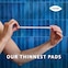 Person holding the TENA Discreet Ultra pad to demonstrate how thin it is, with the caption "our thinnest pads"