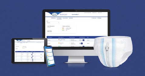 Tablet, smartphone and monitor showing the TENA dashboard, beside a TENA incontinence product with the TENA SmartCare Change Indicator attached