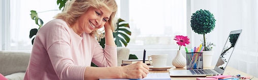 Woman smiling and writing
