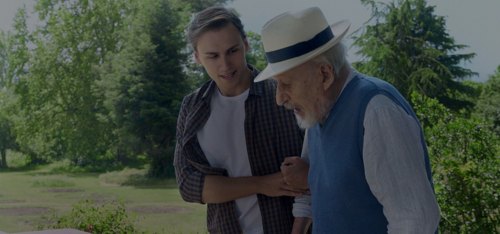 1.	Younger man helping an older man to walk outside 