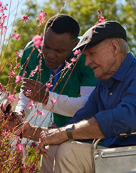 Old women in corridor with nurse