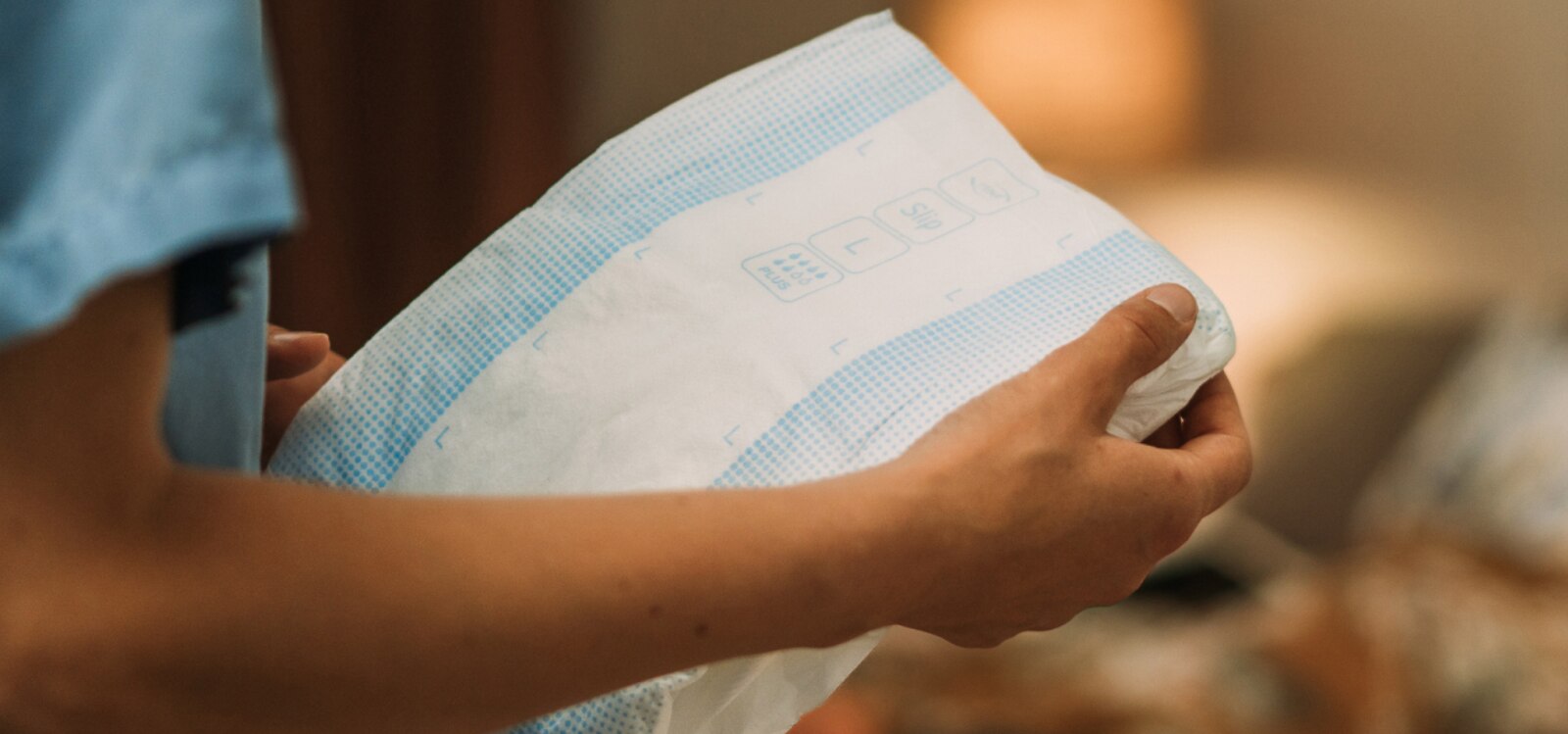 A person holding a TENA ProSkin Slip