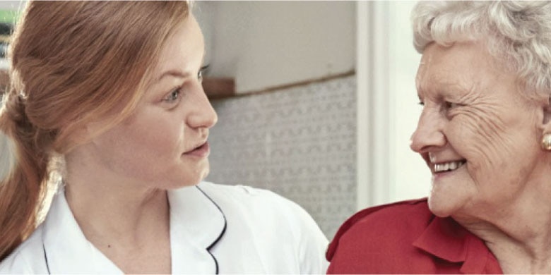Image of Nurse and Resident having a discussion - TENA Professional