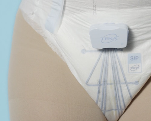 Close on a TENA Identifi absorbent pant product with built-in sensors, worn by a model