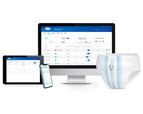 A TENA absorbent pant product fitted with a TENA SmartCare Change Indicator. Behind it stand a computer and mobile devices showing the TENA SmartCare dashboard.