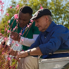 TENA Lifestyle, older woman in hallway with nurse