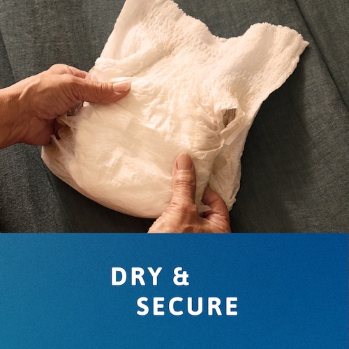 Άτομο που κρατάει διπλωμένο προϊόν TENA Pants στα χέρια του. Η λεζάντα λέει «Παραμείνετε στεγνοί, παραμείνετε ασφαλείς».