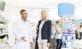 A man and a woman standing in a pharmacy
