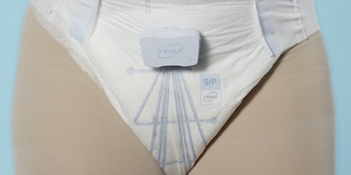 Close on a TENA Identifi absorbent pant product with built-in sensors, worn by a model