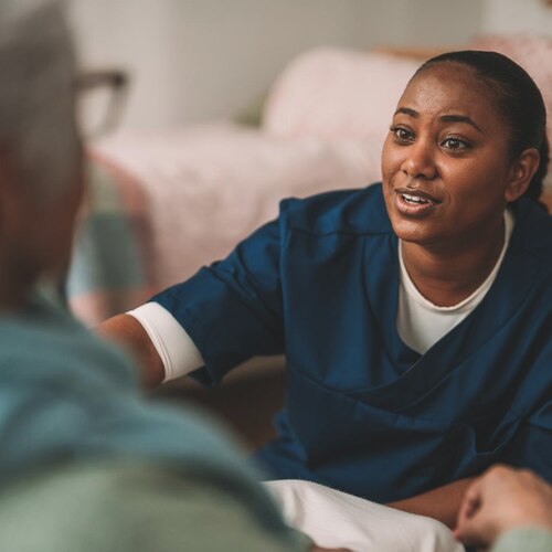 A circle with the words TENA Total Care in the middle. There are four smaller, different coloured circles around the main circle. 