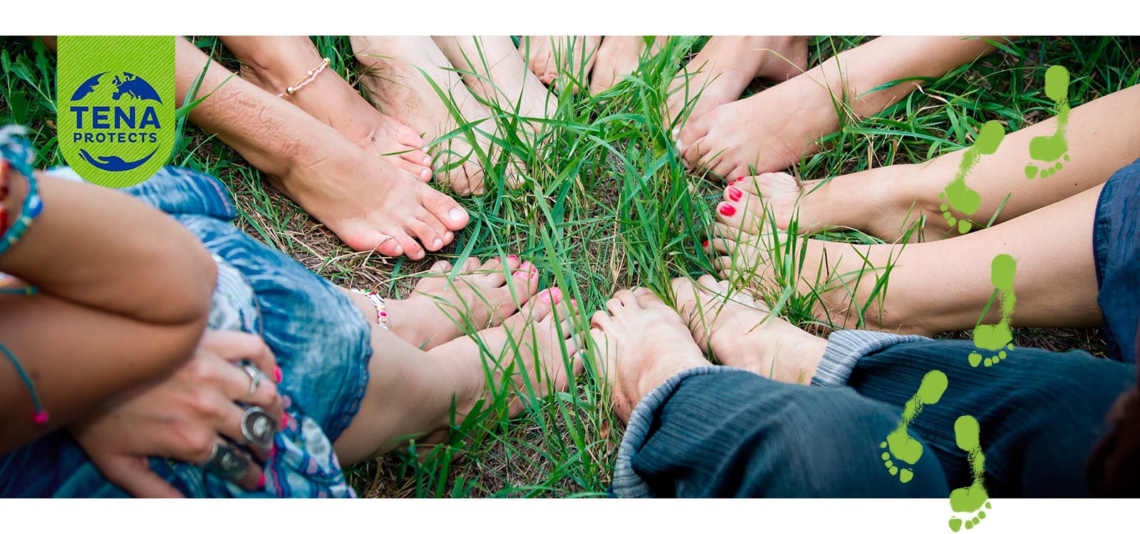 Bare feet of group of young girls in a circle on green grass