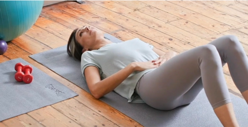Woman lying on yoga mat