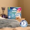 Pack of TENA Pants protect+ on a bed table with triple protection icon