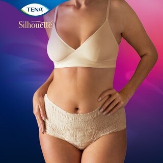A woman wearing TENA Silhouette Creme seen from the front

