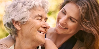 Young woman hugging and older woman Young woman hugging and older woman