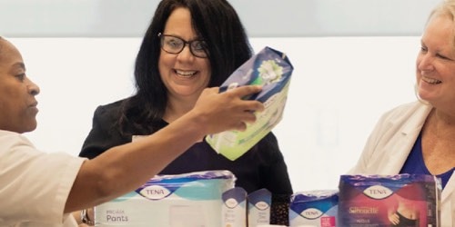 Three female research scientists showcasing incontinence products.