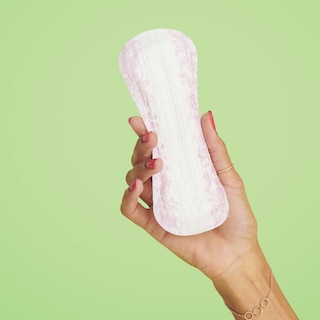 A woman's hand showing TENA Discreet Ultra Mini Incontinence Liner