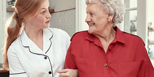 Care home resident talking to a nurse