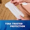 Woman holding the TENA Discreet Ultra pad with the TENA trusted protection Woman holding the TENA Discreet Ultra pad with the TENA trusted protection