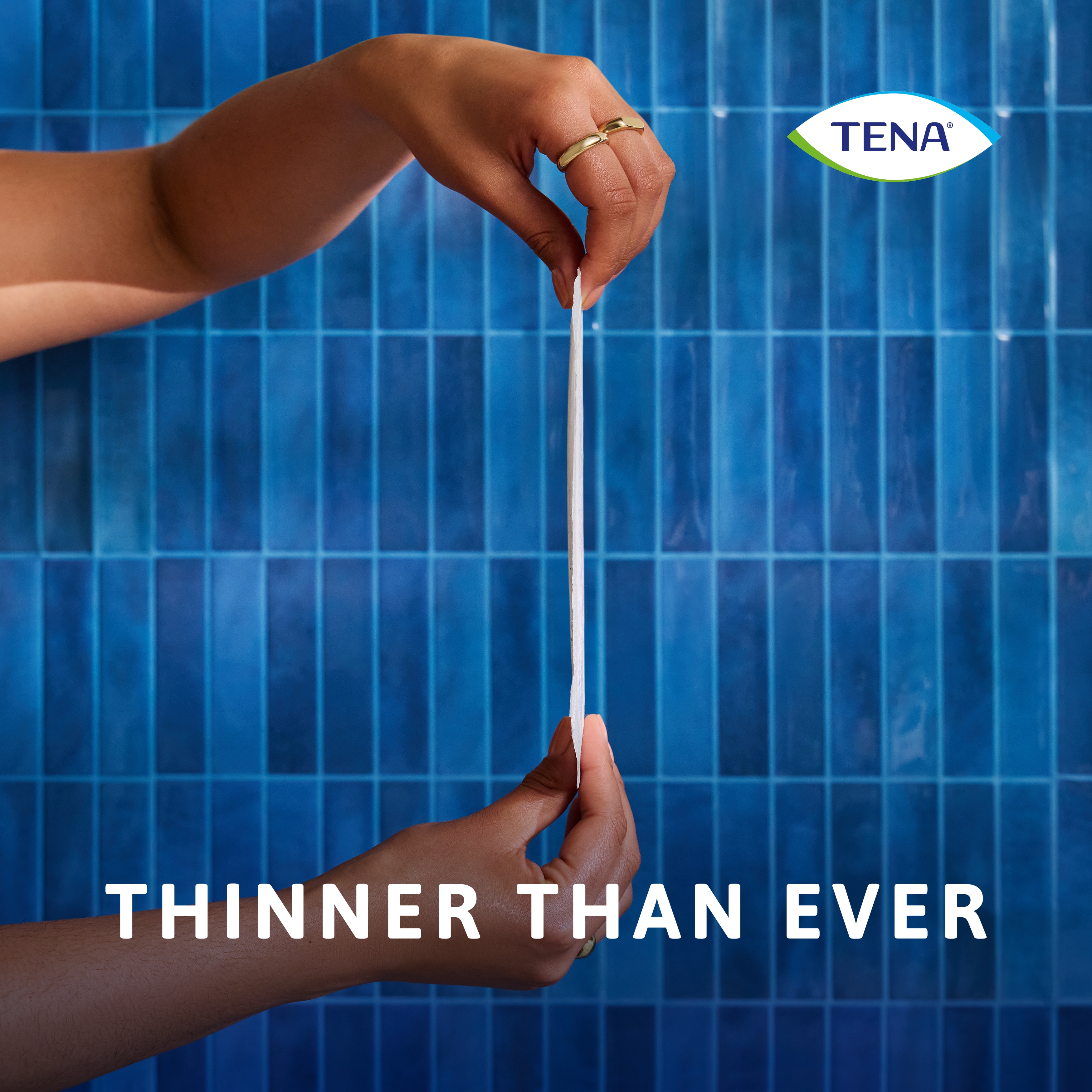 Person holding the TENA Discreet Ultra pad to demonstrate that it's thinner than ever before.