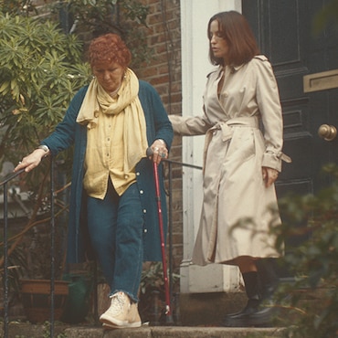 A mother and a daughter going outside for a walk