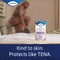 TENA Lights Sensitive Normal pad displayed with a woman putting on clothes, with the caption "kind to skin. Protects like TENA" 