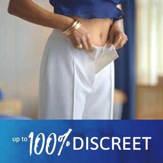A business woman buttoning a pair of white dress slacks while wearing TENA underwear. A text underneath the photo reads "up to 100% discreet".