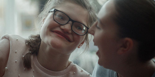 Two women laughing together.