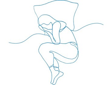 Illustration of a person laying curled up in a bed
