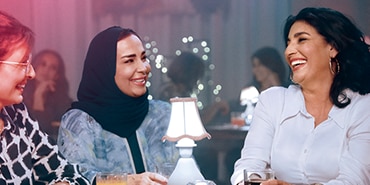 ثلاثة نساء تضحكن بصوت مرتفع