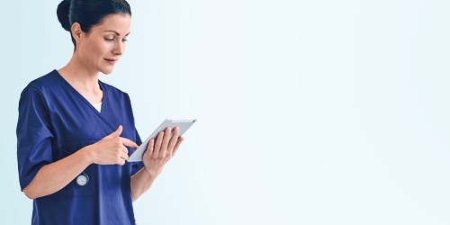 A female professional caregiver using a tablet device 
