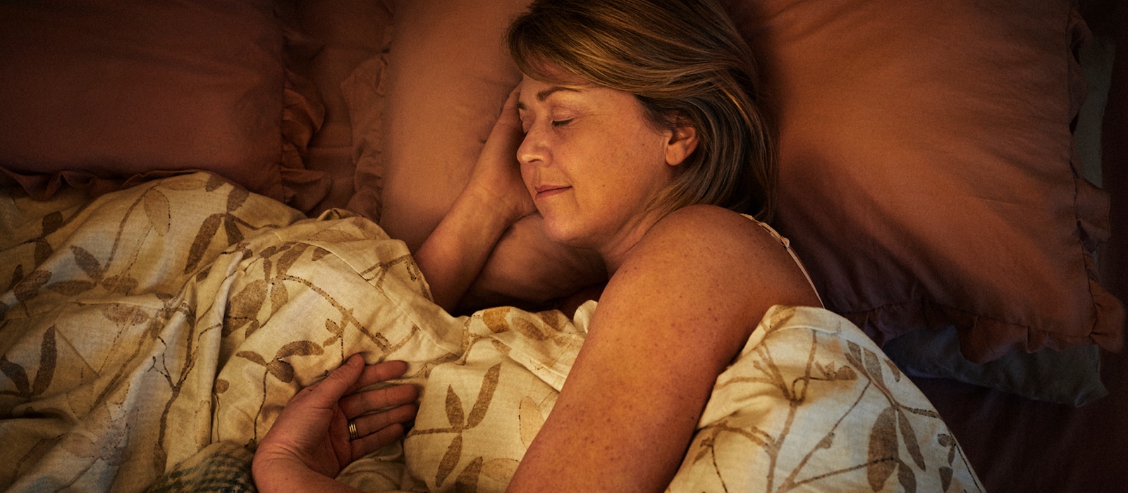 A woman sleeps soundly in her bed.  A woman sleeps soundly in her bed.