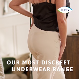 Mulher a usar roupas por cima da roupa interior TENA Silhouette, a nossa gama de roupa interior mais discreta