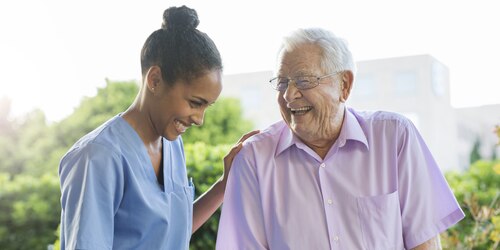 Image of Resident meeting with Nurse and Smiling- TENA Professional