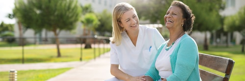 Image of Nurse and Resident on Park Bench  - Partnering With You To Make A Difference - TENA Professional