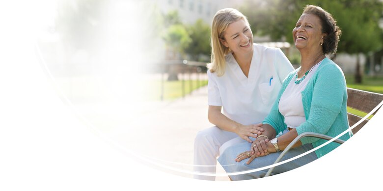 Image of Woman sitting on park bench - TENA Cares - TENA Professional