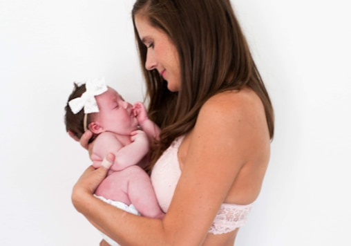 A woman is holding a baby